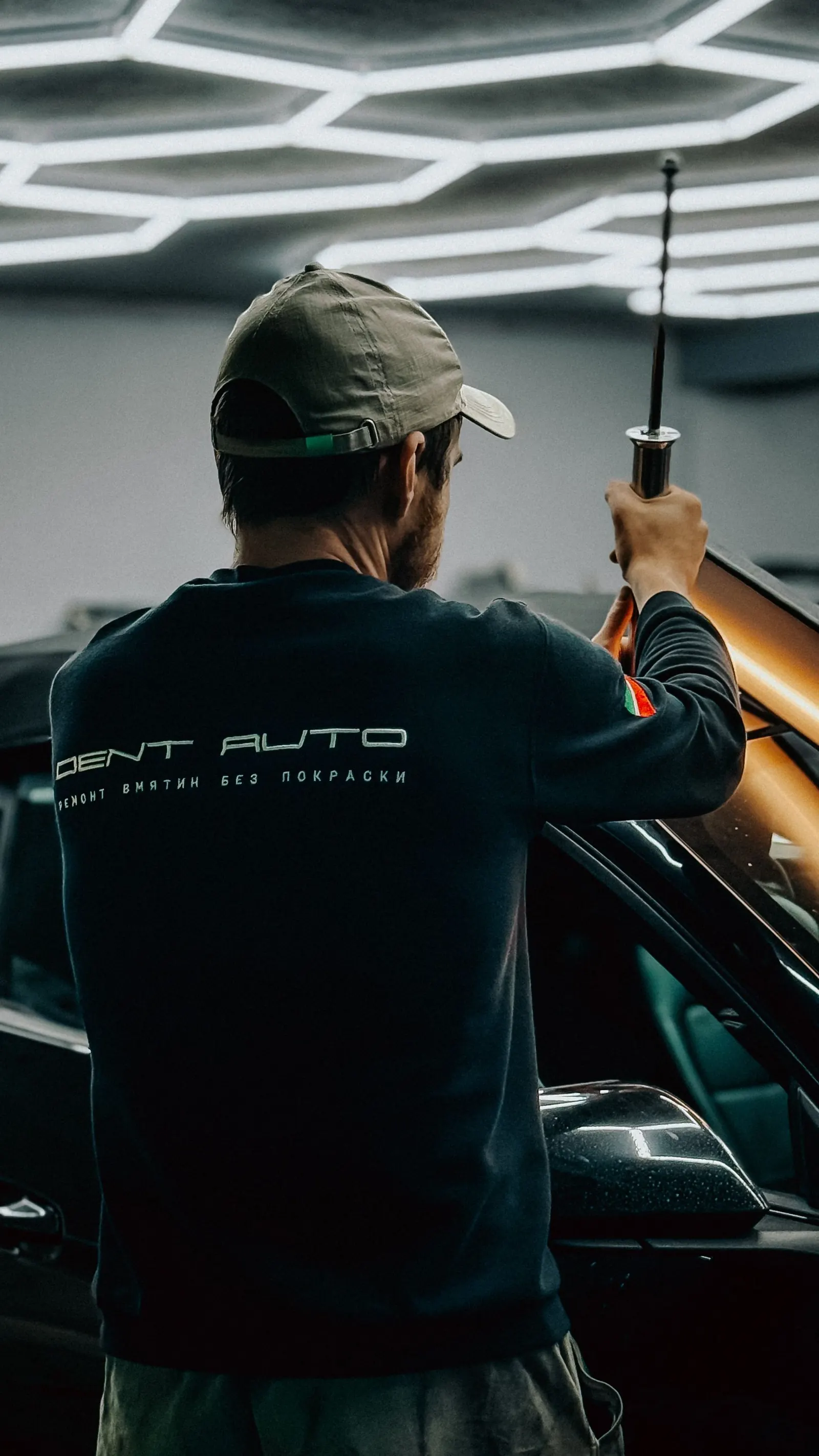 A technician working carefully in a modern garage
