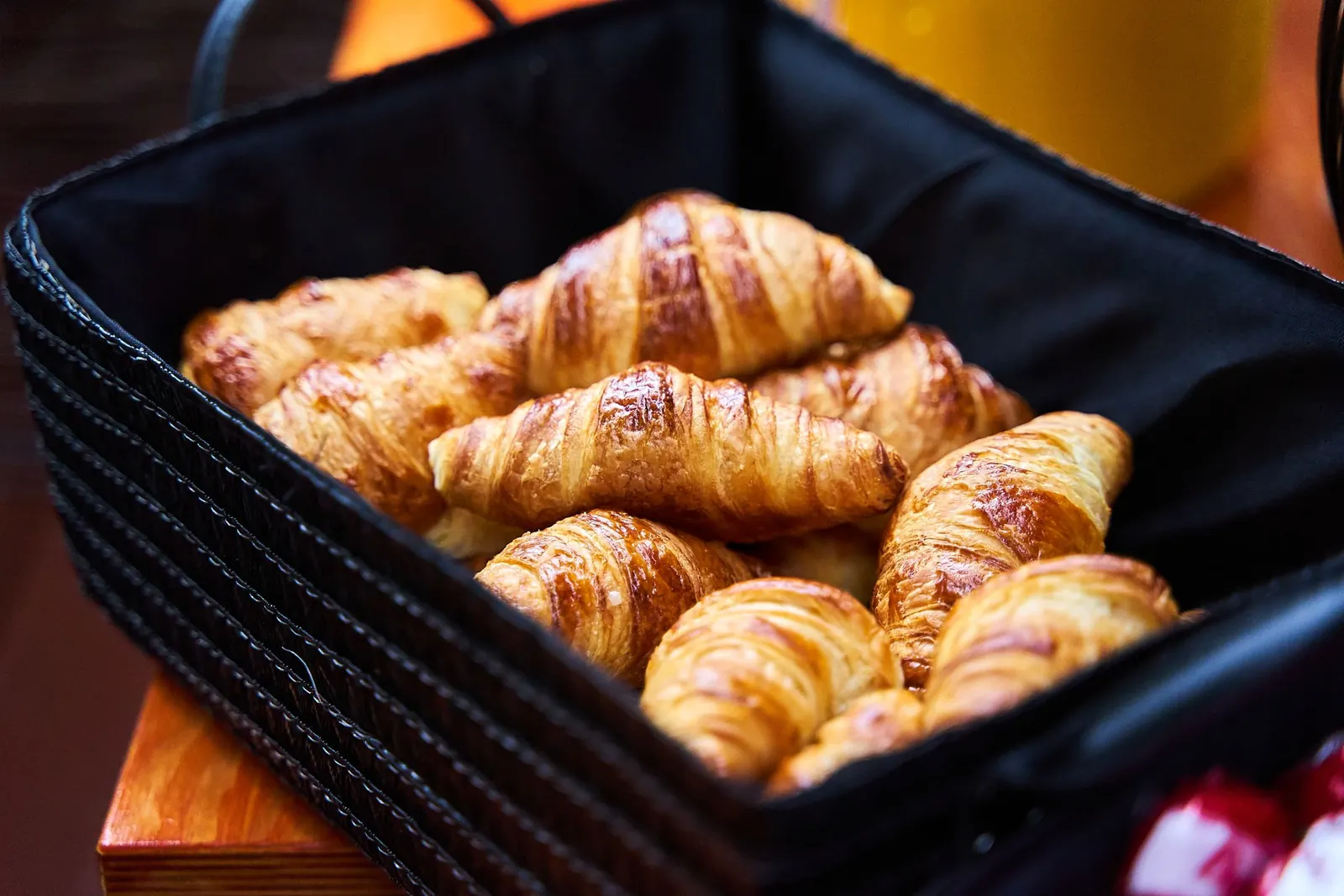 Fresh croissants gathered in a basket