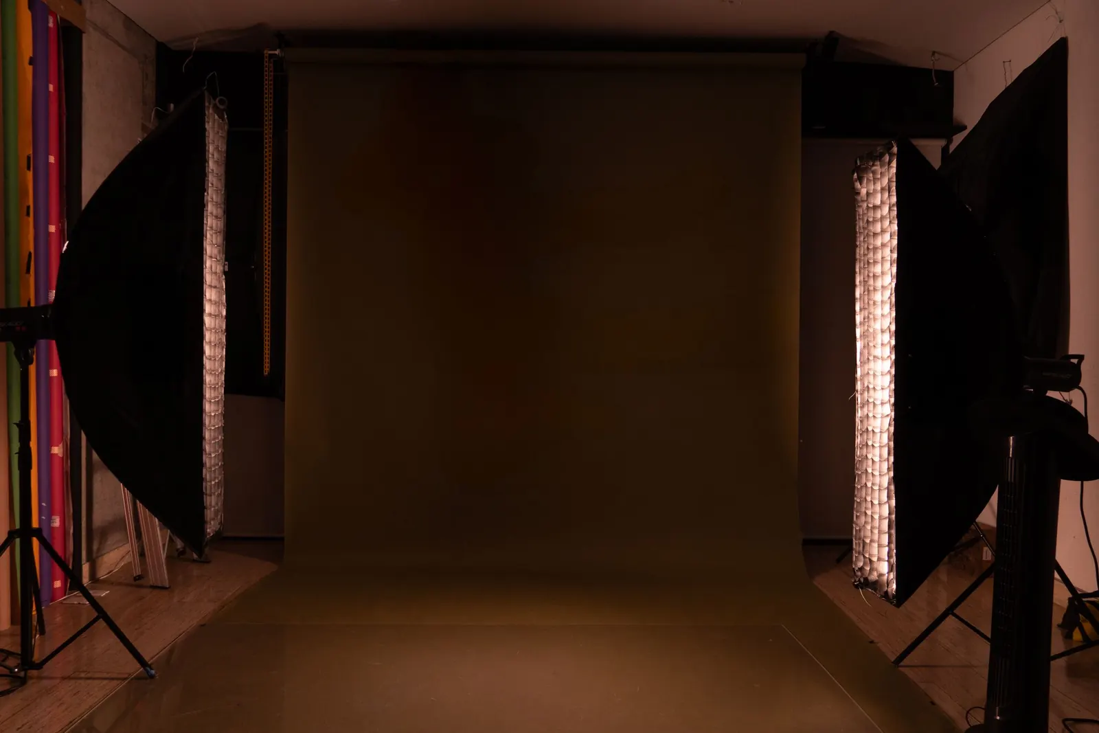 A studio backdrop framed by lighting equipment