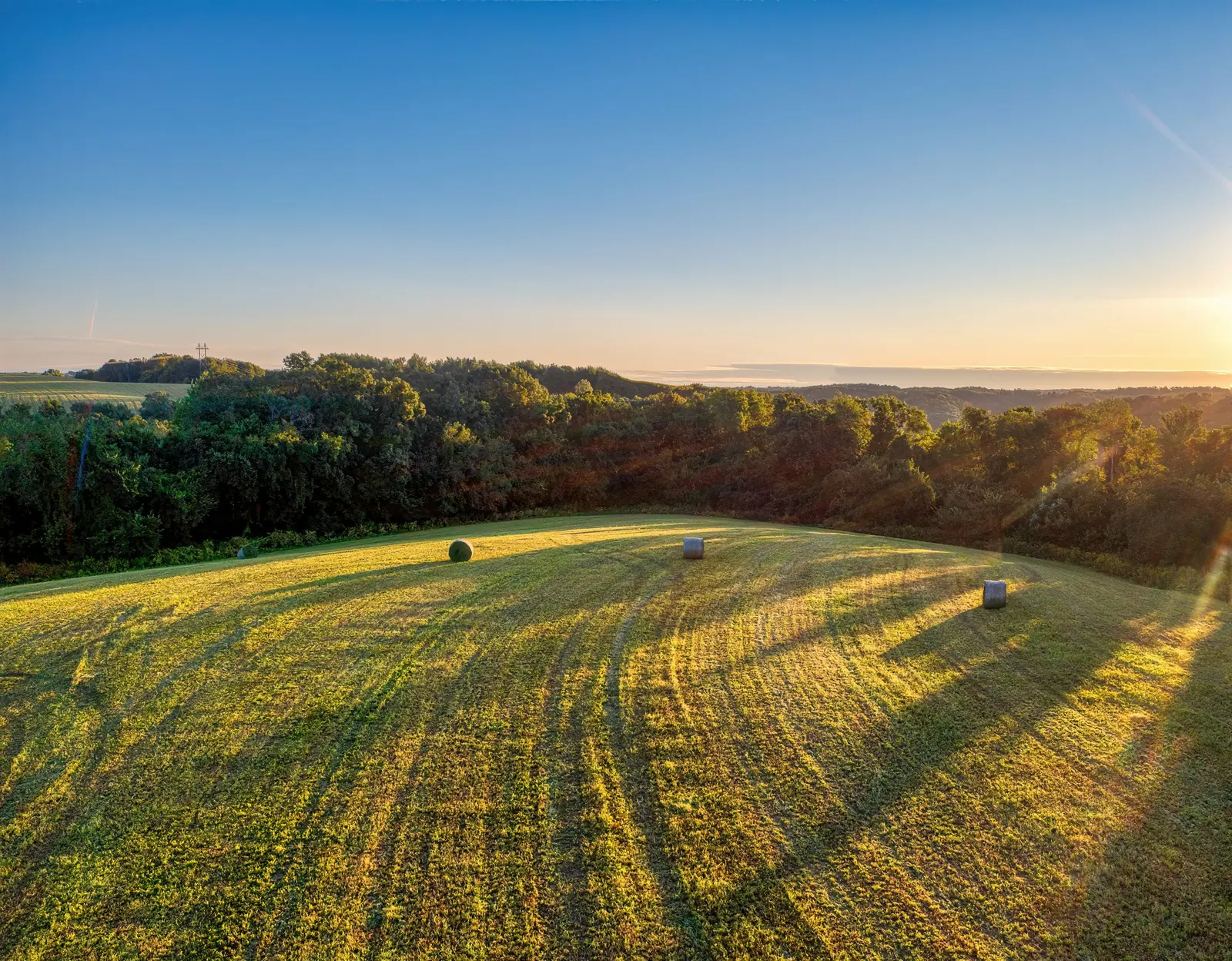Open farmland stretching out at golden hour