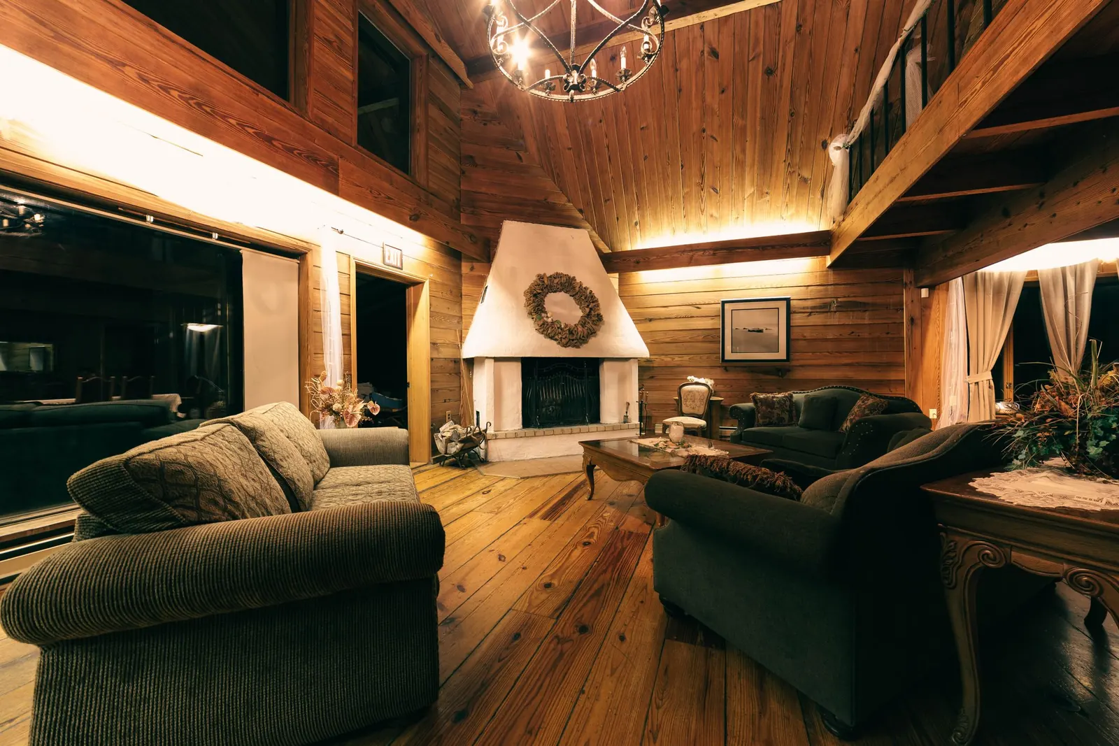 A wood-lined lounge warmed by an open fire