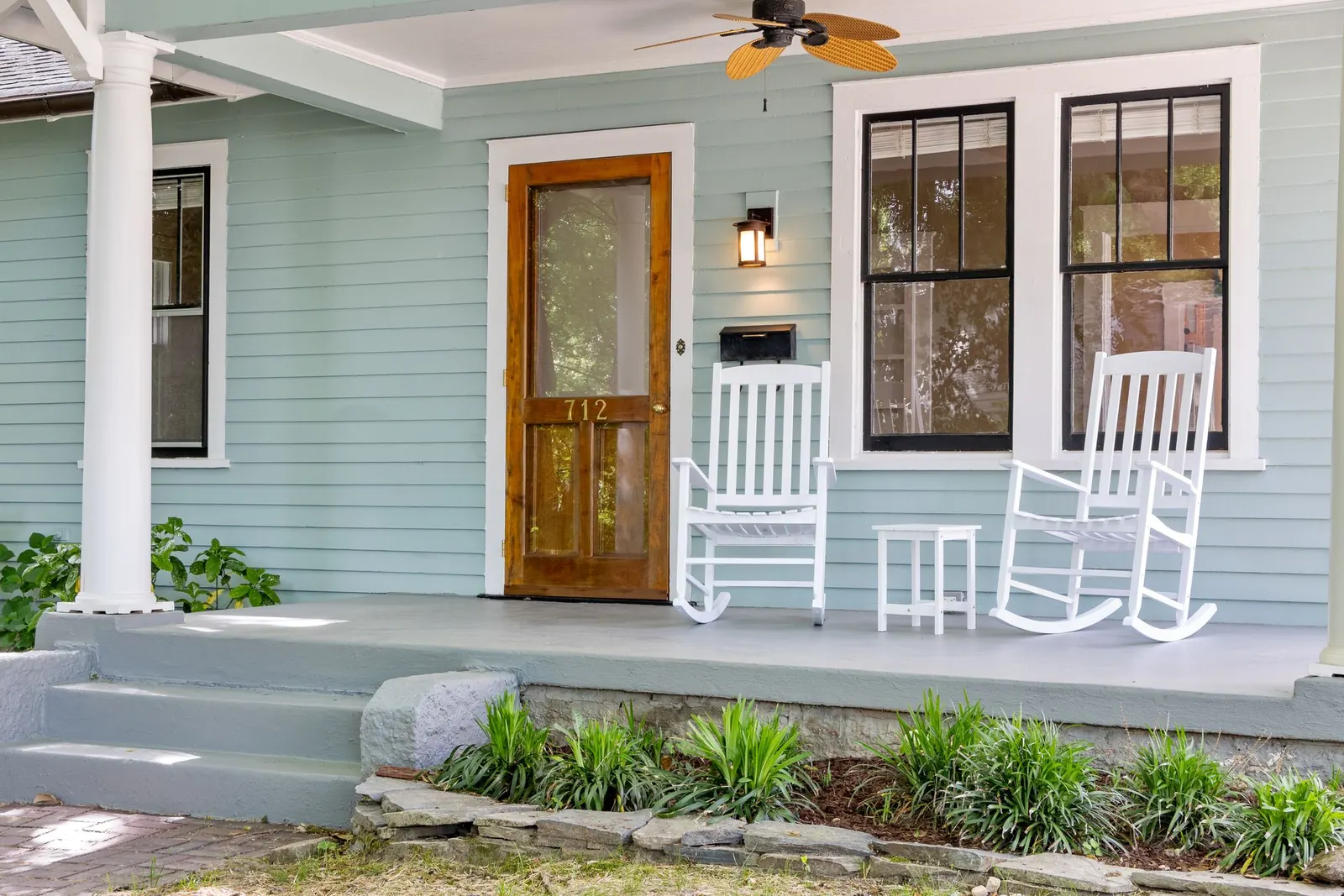 Rocking chairs waiting on a covered front porch