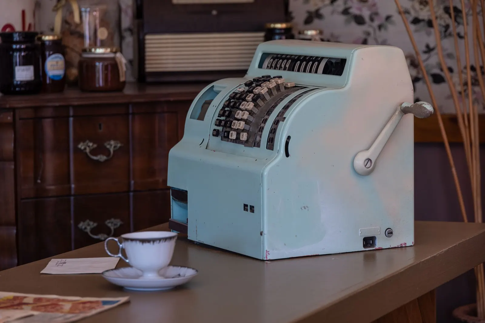 A vintage register on a wooden shop counter