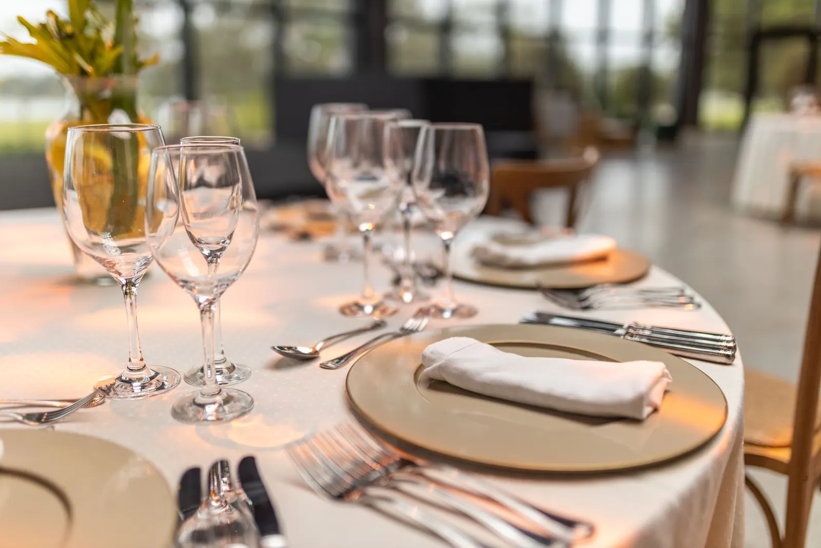 A long table dressed with glassware for a gathering