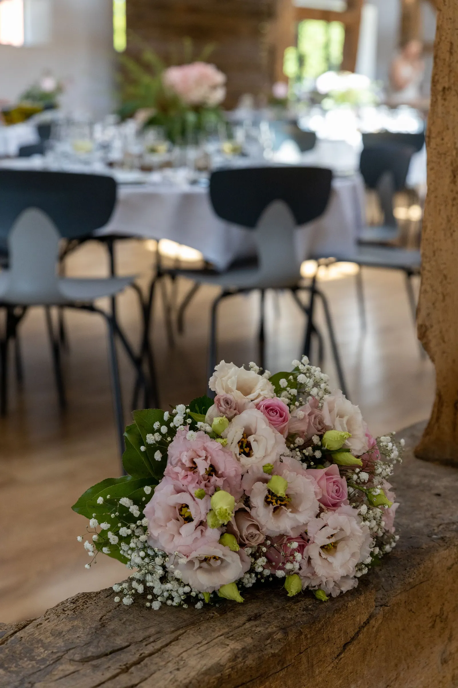 Flowers resting on a table set for a reception
